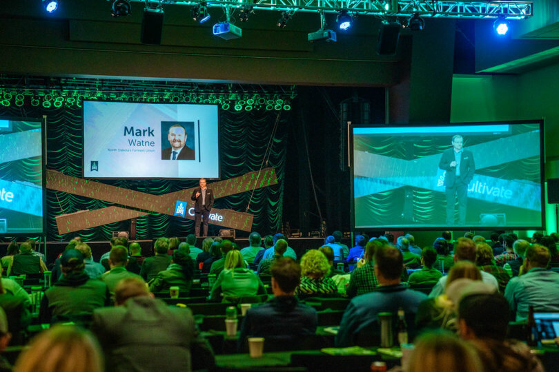 Mark Watne on stage in front of a crowd